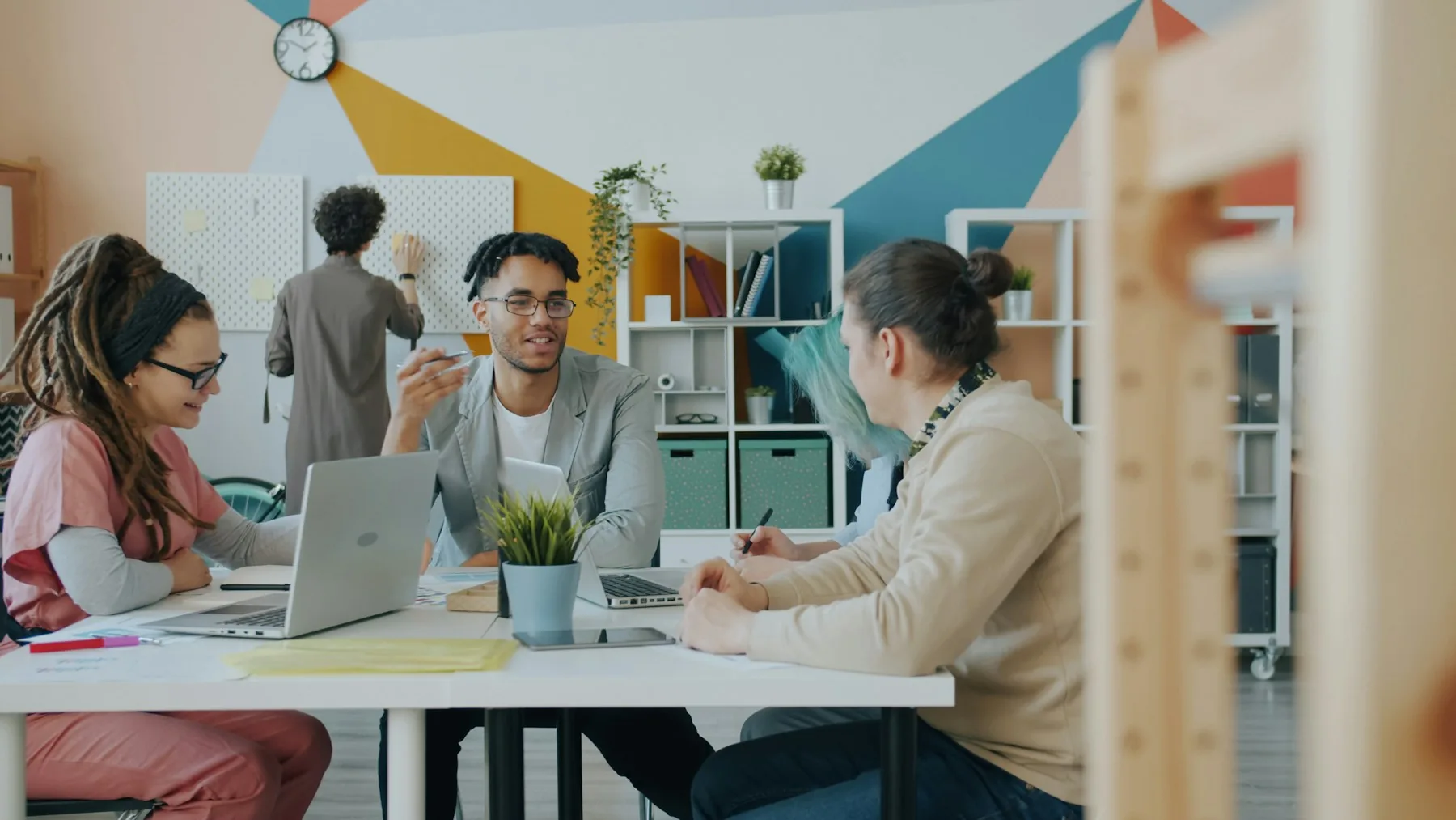 A small office team discussing work around a shared table.
